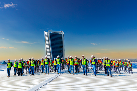 The Sicon Group roofing team on an industrial roof with the Johannesburg skyline behind them