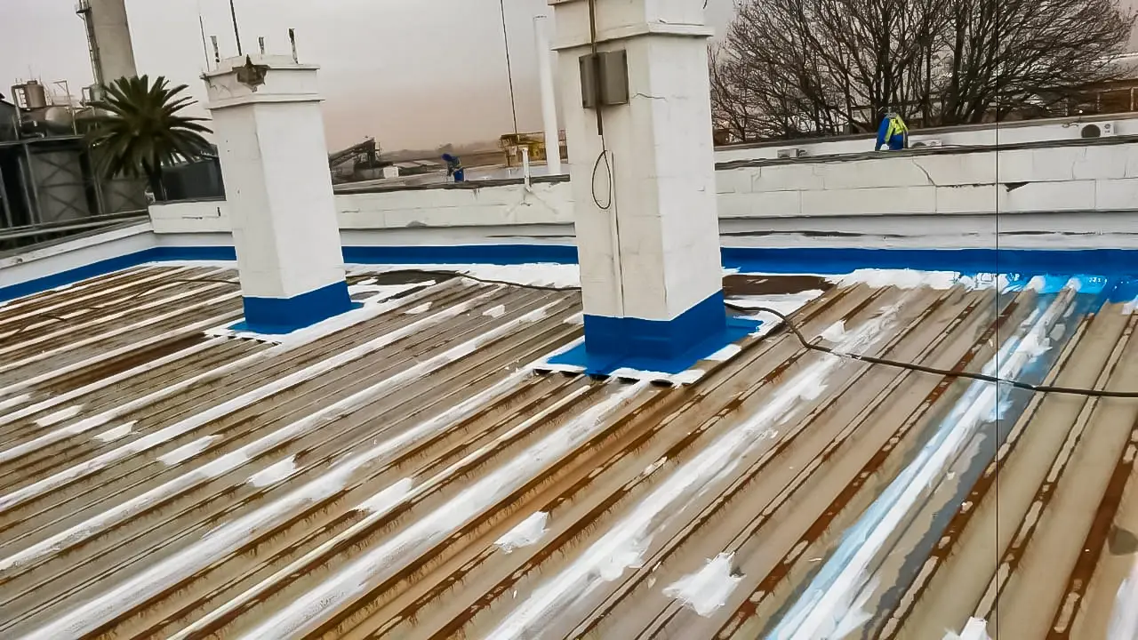 Corroded industrial roof being treated with rust primer and protective coating by Sicon Group