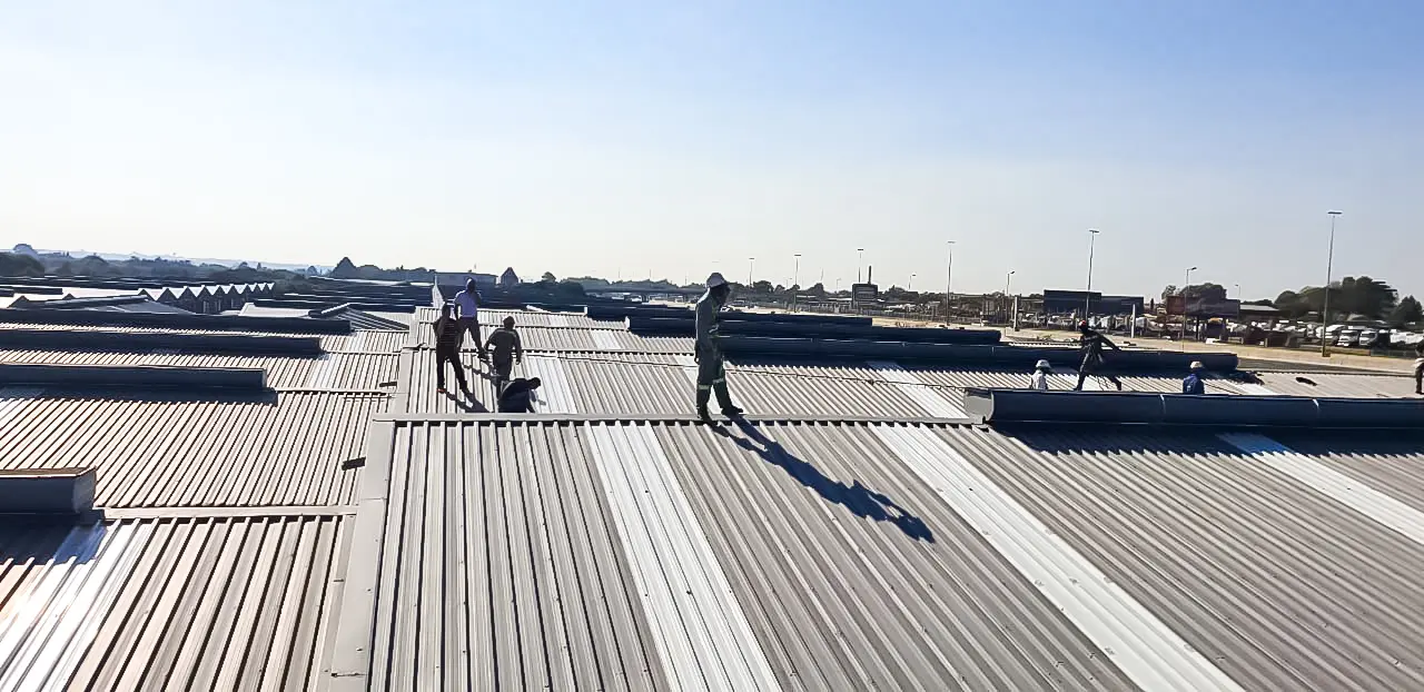 Sicon Group crew working across a large industrial metal roof