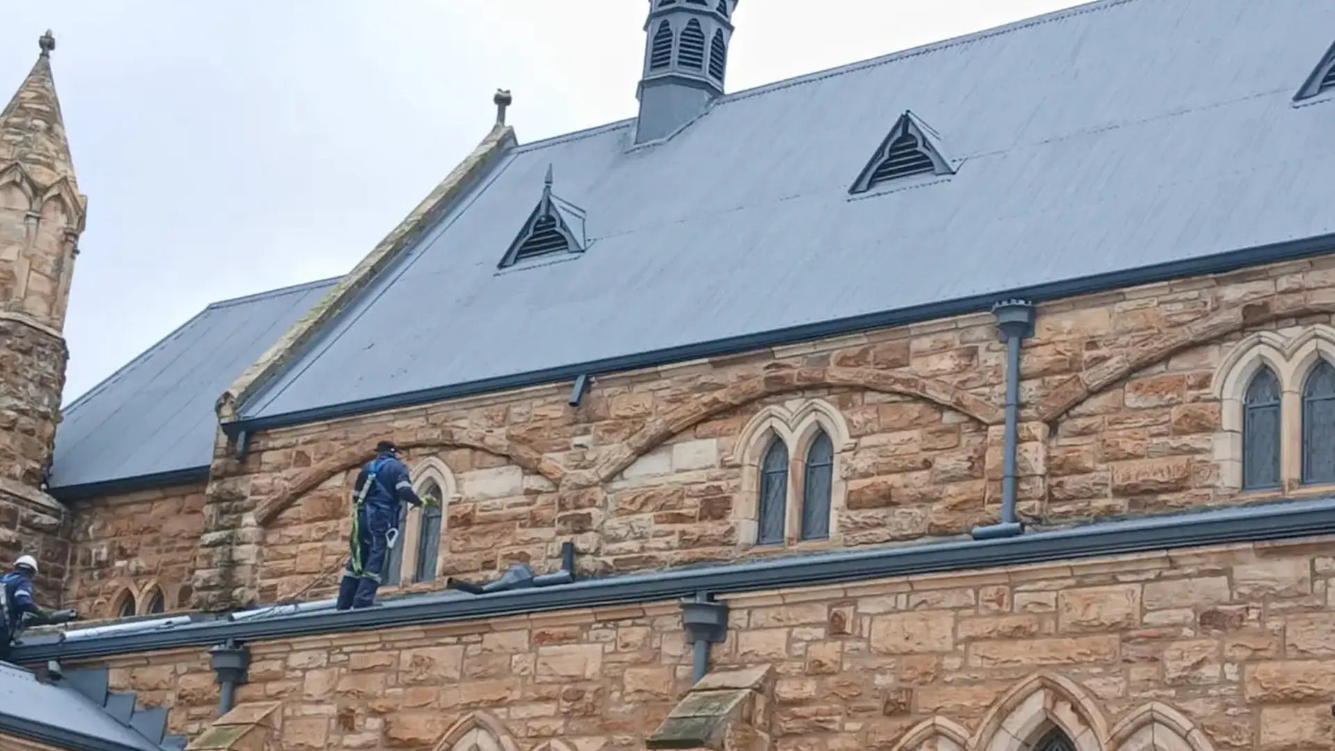 Flat metal roof being serviced and resealed during preventative maintenance by Sicon Group