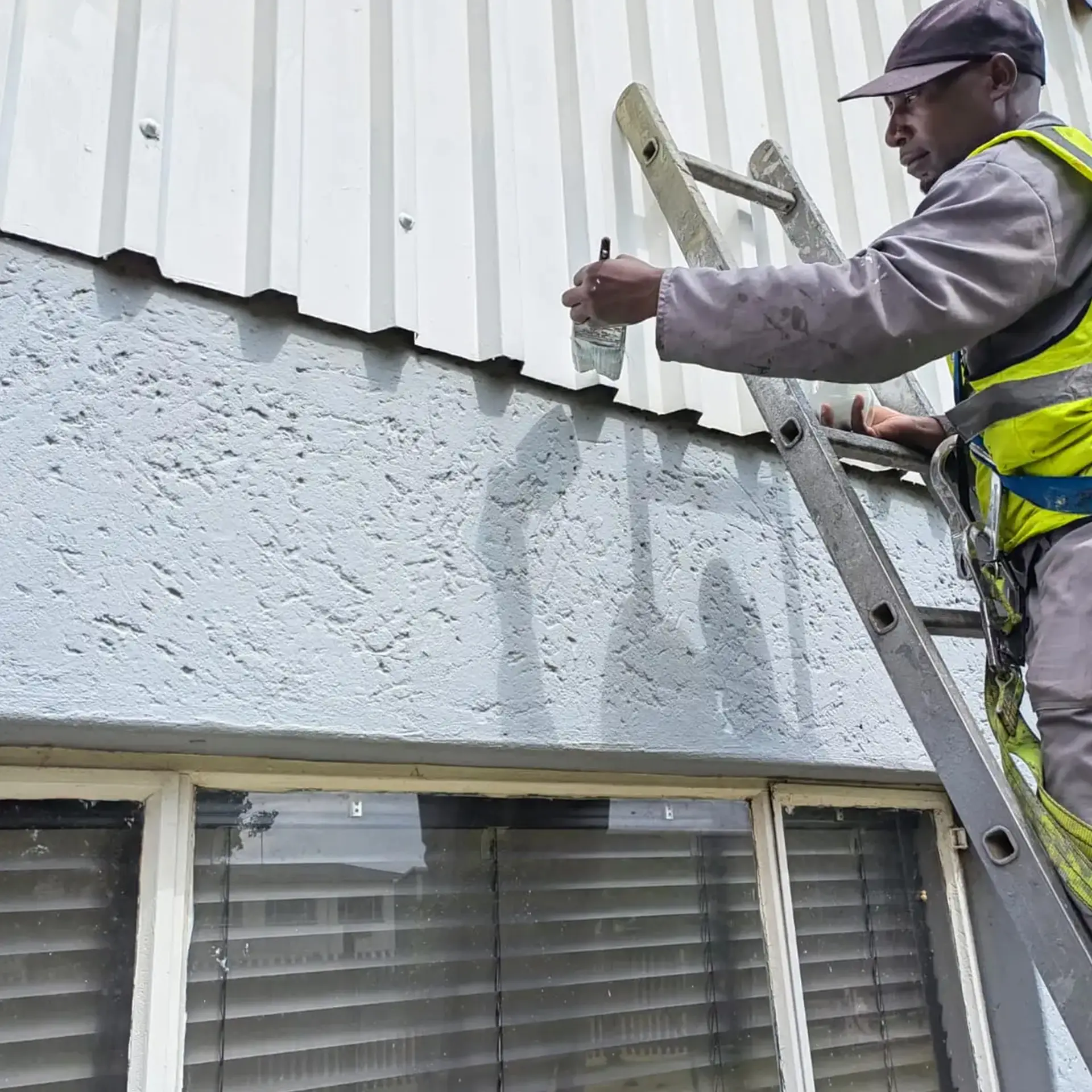 Close-up of seal upkeep along a gutter edge to prevent corrosion on a commercial rooftop