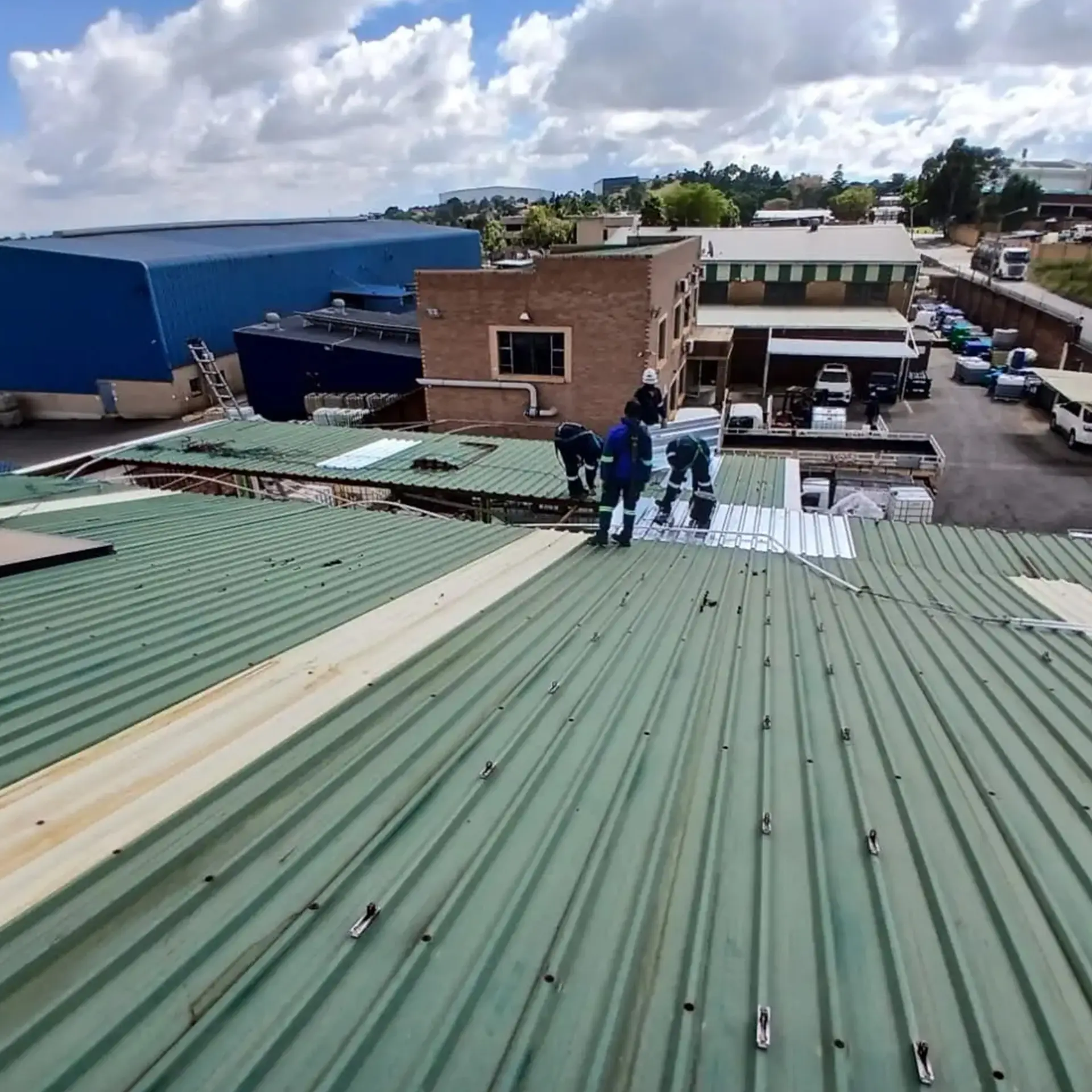 Sicon Group technicians servicing and securing metal roof panels during maintenance