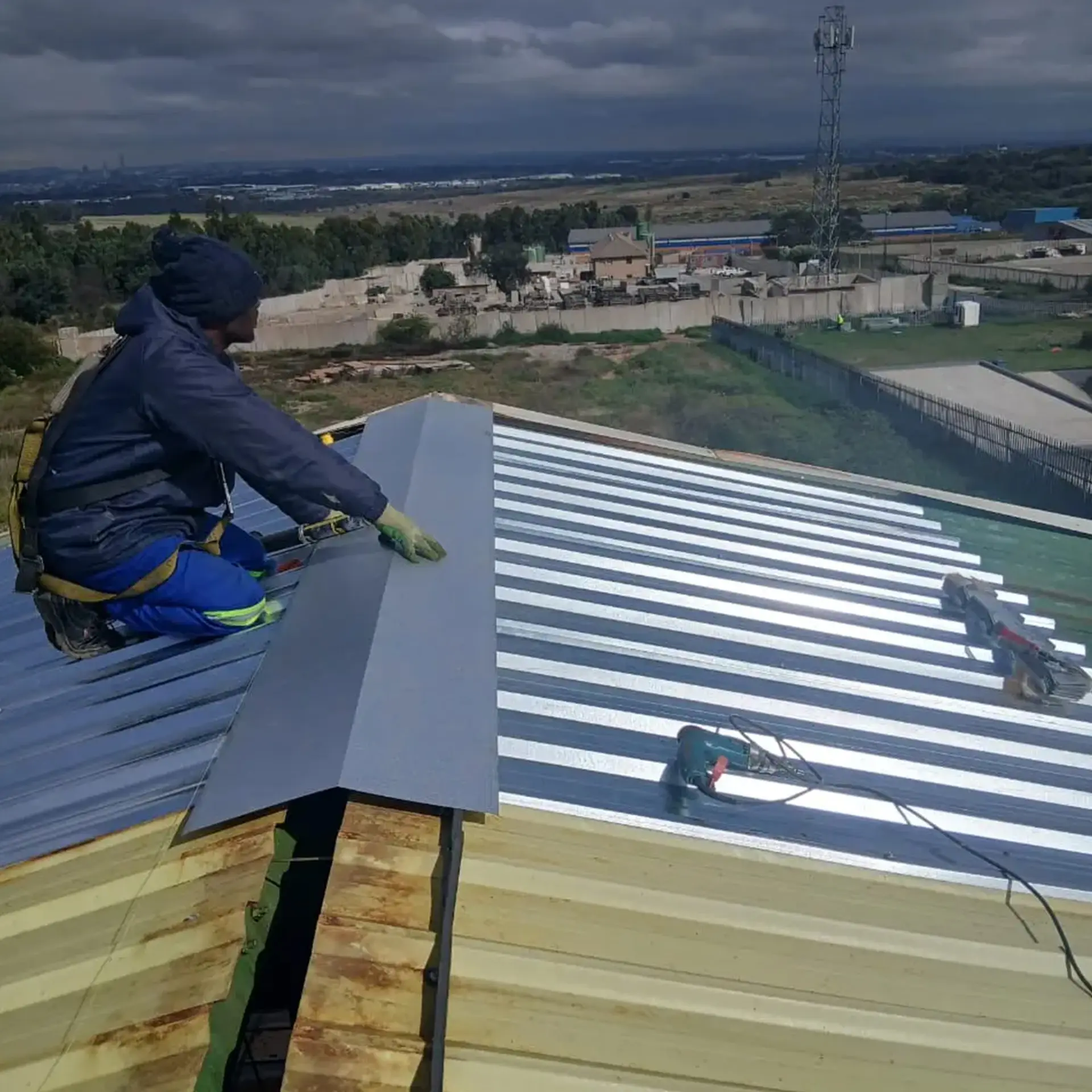 Sicon Group team re-fastening metal roof panels during a detailed maintenance visit