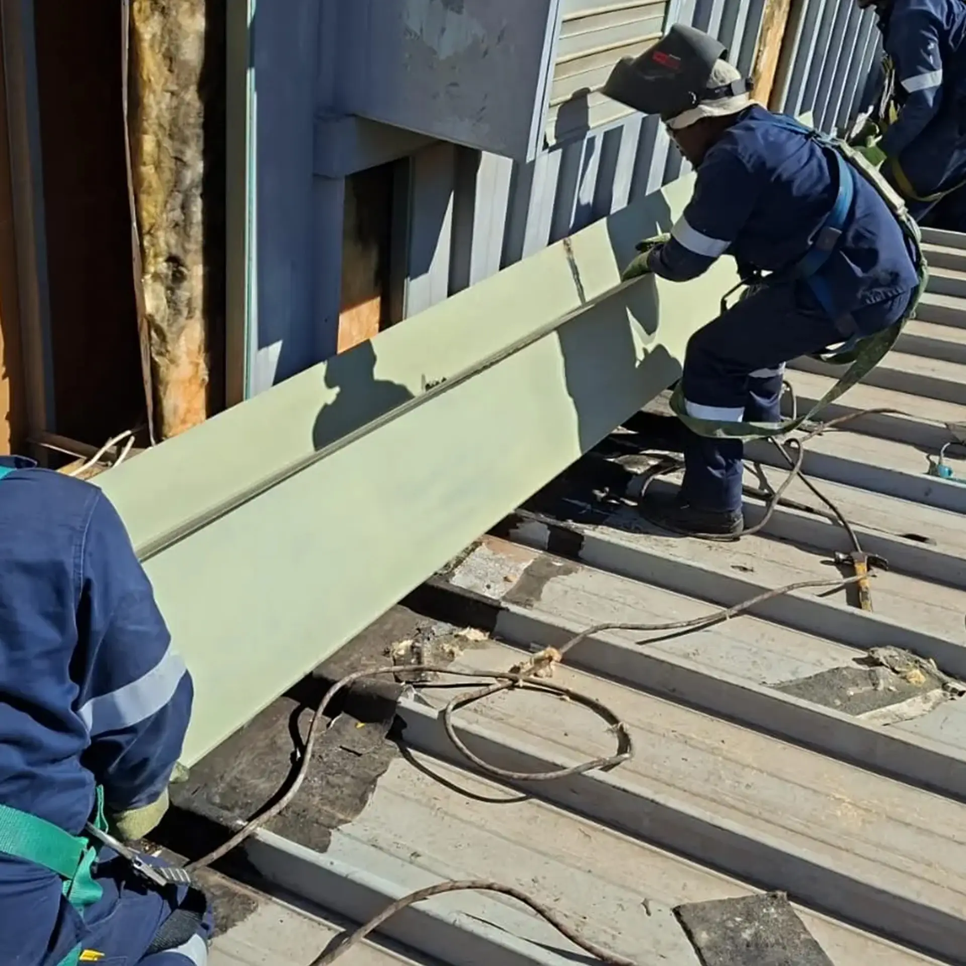 Sicon Group specialist applying sealant during scheduled maintenance of an industrial pitched roof